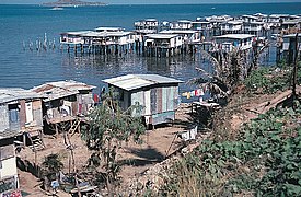 Southern coastal village over water in Papua New Guinea.jpg