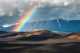Volcanic land and rainbow