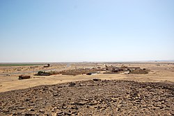 Looking south, the Hejaz railway station building in the distance behind the village