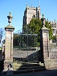 Gates, gatepiers and steps at south-west corner of churchyard