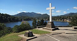 A Christian cross stands above the resort