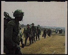 Marine watches men of Company C, 2nd Battalion, 7th Cavalry approaching at Khe Sanh Combat Base.jpg