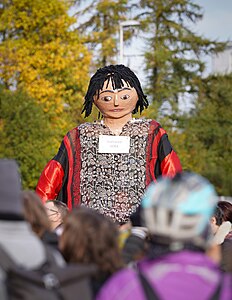 Model representing children displaced by climate change carried through streets of Glasgow during protests of inaction on climate change on 10 November during the climate conference