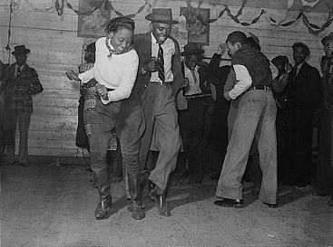 Social dance – dancers at a juke joint dance the Jitterbug, an early 20th century dance that would go on to influence swing, jive, and jazz dance