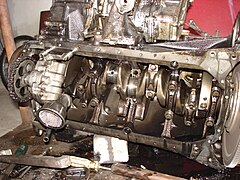 An OM601 engine with a removed oil-pan. Overview of the crankshaft and piston rods.