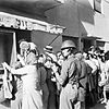A soldier of the 6th Airborne Division maintains order outside a bakers shop in Tel Aviv