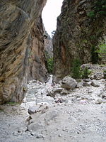 Tourists walking through a gorge