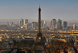 The Eiffel Tower (foreground) and the skyscrapers of Paris's suburban La Défense business district (background).