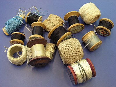 Traditional wooden spools of the sort used to hold thread, with a few nails driven into one end, make knitting spools.