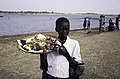 A young Bozo woman is selling jewelry, Djenné on the Niger River