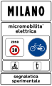 Town sign: start of urban area where electric micromobility is being experimented (50 km/h speed limit, no use of horn and particular caution to cyclists and motorized scooters)[6]