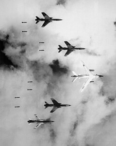 A United States B-66 and four F-105 of the 20th TRS dropping bombs on North Vietnam during Operation Rolling Thunder, June 1966