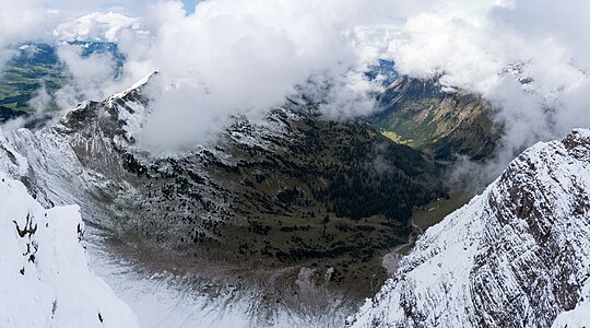 Cloudy sky in valley Retterschwanger Tal, view from mountain Nebelhorn in September to mountain Entschenkopf