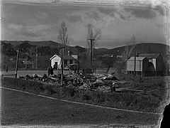 View across a road of a debris pile in a township section (AM 76058-1).jpg