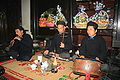 Image 10A trio of Vietnamese musicians performing together. The man on the far left plays kèn đám ma, the man in the middle plays the đàn nhị and the man on the right plays the trống chầu. (from Culture of Vietnam)