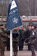 An Honor Guard of Italian Soldiers hoists the new Stabilization Force (SFOR) flag at the SFOR activation ceremony held at the Ilidza compound, Sarajevo, Bosnia-Herzegovina. The cere - DPLA - f30fa28ac17eb1b972804556a3ba0c4a.jpeg