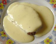 Crème anglaise served atop a slice of pain d'épices and pooled on the plate