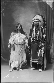 Photographic portrait of Pohene and Frank George, two Shoshone people in traditional dress