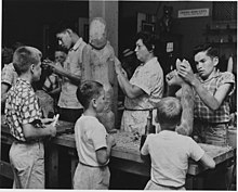 Amanda Crowe demonstrating woodcarving at the Craftsmen's Fair in Cherokee, North Carolina