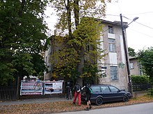 Exterior of building, people entering through gate