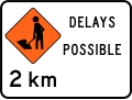 (TW-1B2.2) Road workers ahead in 2 kilometres, delays possible