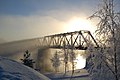 Mist rising from Oulujoki river embraces the Vaalankurkku railway bridge near Vaala station in Finland.