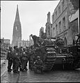 Britische Panzereinheit am 4. April 1945 auf dem Prinzipalmarkt. Im Hintergrund die Lambertikirche mit beschädigtem Turm und zerstörtem Dach.