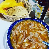 Birria with warmed tortillas and beer