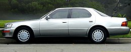 Side profile view of a sedan parked on a street.