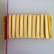 Sheets of pasta are folded and sliced into noodles