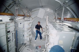 Cosmonaut Yuri P. Gidzenko is dwarfed by transient hardware aboard Leonardo MPLM