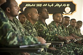 Maldivian marines listen to U.S. Marine Corps Master Sgt. John Martinez, not shown, a mobile training team chief with Marine Corps Forces, Pacific, during a meet and greet for an upcoming noncommissioned officer 140117-M-BO337-003.jpg