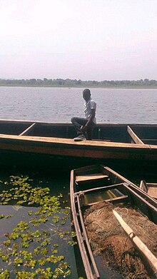 A man using a boat as transport means on Rivernile Rhinocamp Madi okollo District