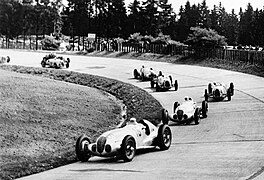 Shortly after the start of the German Grand Prix, Lang leads ahead of Caracciola (1937) (1937).jpg
