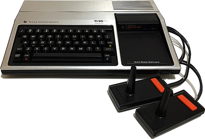 An 1981 Texas Instruments 99/4A computer with two joysticks attached.