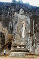 The gigantic standing Buddha – at 16m, it is the tallest on the island – in the centre still bears traces of its original stuccoed robe, and a long streak of orange suggests it was once brightly painted