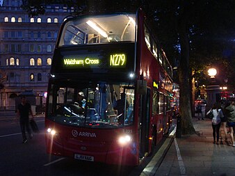 A red London Bus at night with the headboard set to Waltham Cross, N279