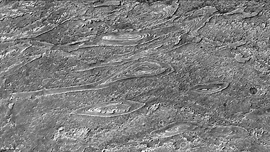 Crommelin crater showing layers arranged in the shape of ovals, as seen by CTX camera. Note: this is an enlargement of a previous image of Crommelin crater.