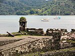 Ruins of stone fortifications near water.