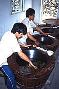 Workers performing fixation (Kill-green) on tea leaves at a Chinese plantation, 1987