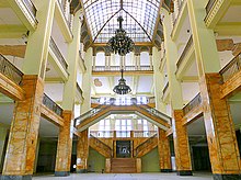 Atrium of a large, multilevel building of a defunct department store flagship. Note the damaged ceiling in the background