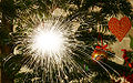 A sparkler as decoration on a Christmas tree