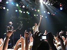 Three men performing onstage