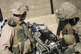 US Navy 061103-M-7387J-040 A recovery team works to secure the black box of an unmanned aerial vehicle which crash-landed on the roof of a house in the city of Hadithah.jpg