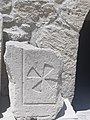 A Drawing of a cross in stone