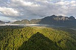 Thumbnail for File:Conical shadow of Mount Nam Xay over green trees at golden hour, South-West view from the top, Vang Vieng, Laos.jpg