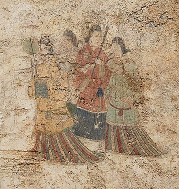 Women's dress under Goguryeo influence, with overlapping collar and mo skirt.[16] Takamatsuzuka Tomb, c. 686 CE.[17]