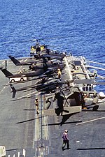 US Army Sikorsky UH-60 Black Hawk, Bell AH-1 Cobra and Bell OH-58 Kiowa helicopters on deck of the US Navy aircraft carrier USS Dwight D. Eisenhower (CVN-69) off Haiti, 1994.