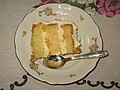 Slice Argentine homemade cake of vanilla sponge cake with whipped cream and peaches au naturel