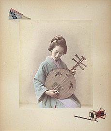 A Japanese woman playing the gekkin. Photo by Adolfo Farsari, 1886